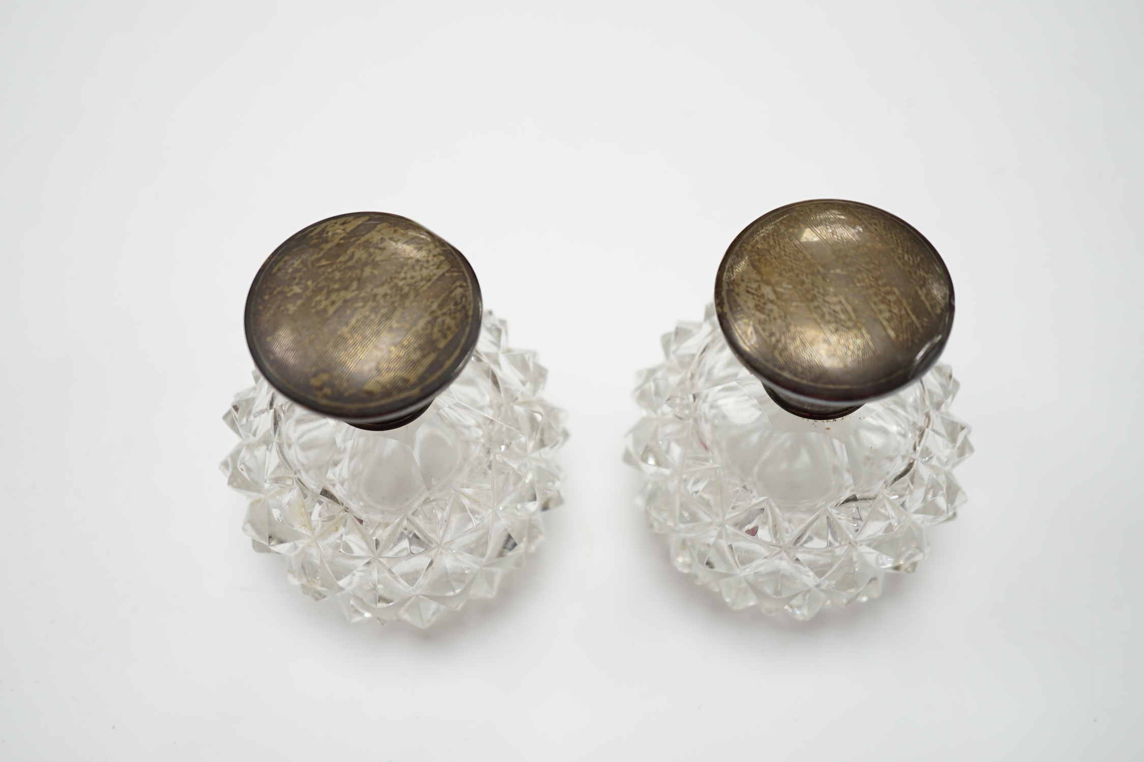 A pair of silver mounted scent bottles, 10cm
